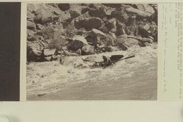 Nevills at the oars and Ed Reek as passenger in the right side of Piute Rapid-  Movietone San Juan trip in 1945