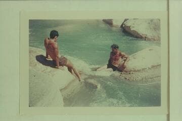Swimming through a chute in Supai Creek.   Garth Marston is at left, Bruce Wilson is swimming underwater and Norm Nevills is at right