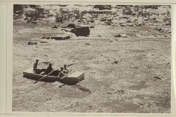 Running Government Rapid on the San Juan.  Frank E. Frost, Skipper at the oars.  D. A. Miller sits aft.  Samuel Johnson left in front and Dr. Sherman A. Wengerd to the right