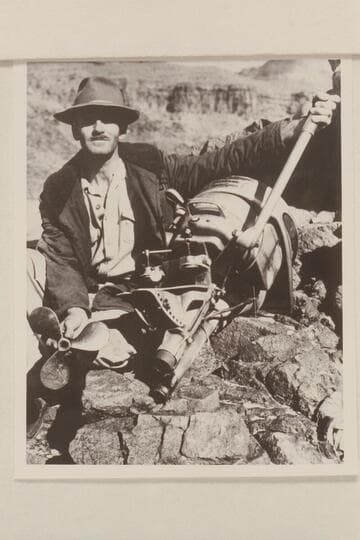Harry Aleson with the 4 cylinder Evinrude Sportfour which was wrecked in Granite Springs Rapid when he was attempting to run up the Grand Canyon in February 1944