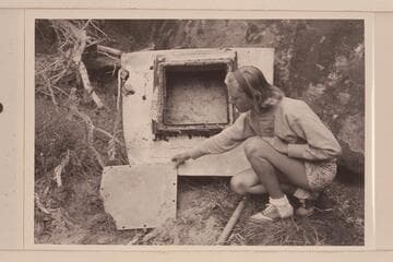 Shirley Marston studies the metal stern section of the "Lota-Ve" left at the foot of Triplett Falls