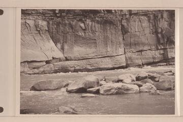Undercut cliff at lower end of Triplet Rapid. A. K. Reynolds running the "Lodore" in the low water