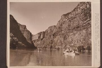 Near head of Canyon of Lodore. Nevills oars the boat at left and Kent Frost is at right