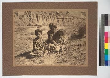 Old Navajo woman said to be over a hundred years old. The children are her great, great grandchildren