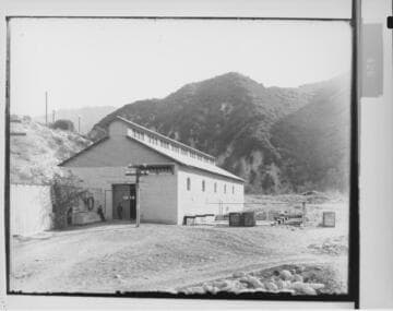 Two men standing outside Santa Ana River #1 Hydro Plant