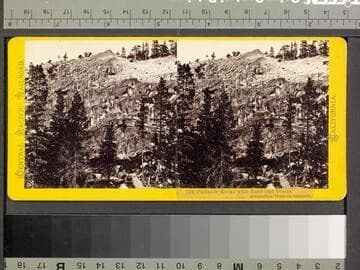 122. Palisade Rocks with Road and Teams descending Western Summit