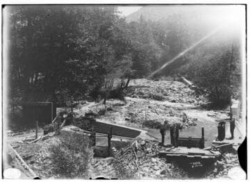 Dam and intake at Mill Creek #3 headworks with men operating the gate controls