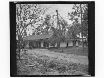 Unidentified house with windmill in background