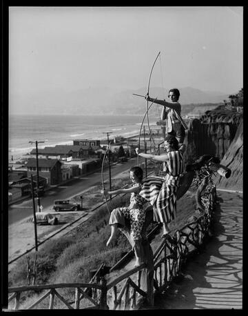 Models posing as archers on the road to Palisades Park, Santa Monica