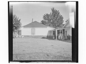 Unidentified house with wooden doors on window