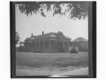 Unidentified brick house with wrap-around porch