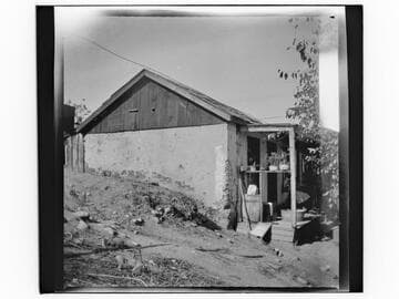 Adobe house with writing on wall