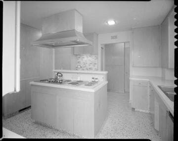 Residential kitchen with electric range on island