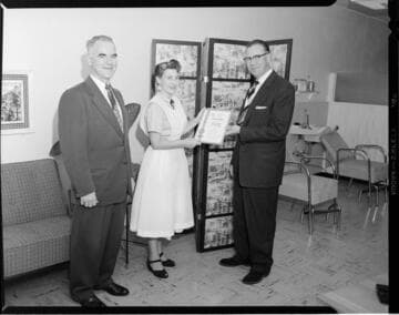 Award of Merit being presented to proprietor of Andree de Paris Beauty Salon