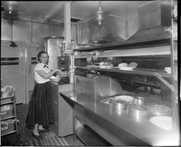 Waitress taking buns from bun warmer