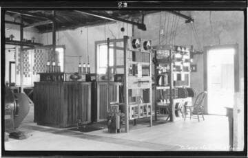 The interior of the Tulare substation with a chair by the switchboard