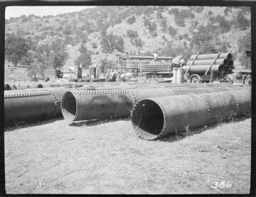A construction crew unloading pipe for the construction of Tule Plant