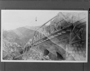 A construction crew posing for a picture on the bridge they are working on