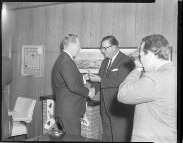 Executives posed exchanging checks