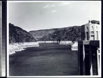 Lake Mead from dam crest with Lake Mead at low capacity showing high water mark on sides of canyon walls and one of the intake towers on the right
