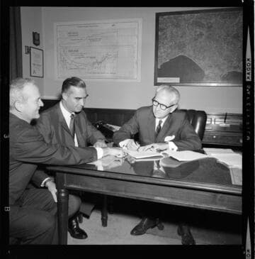 3 men signing contracts