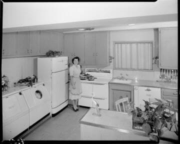 Woman in all electric kitchen