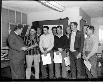 Nine men receiving certificates from Edison Electric Institute