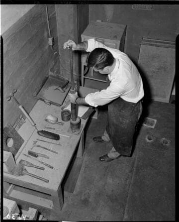 Man is working at a workbench