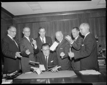 Men making tax payments to Los Angeles tax collector