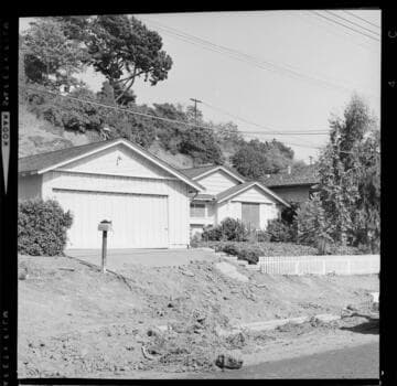 Mud-slide damage to homes in a foothill area