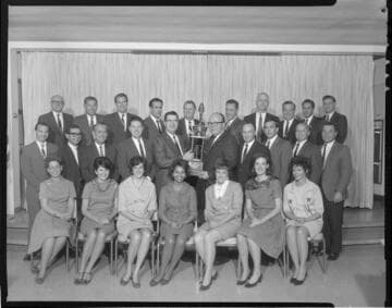 Group photo with Division Award (trophy) for Outstanding Sales Performance