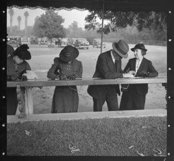 Visitors signing cards for admission to exhibitions of the Huntington library, February 1938