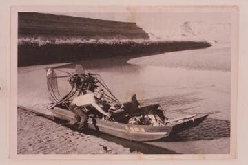 Dean Reynolds, of Vernal, with air boat lost by him and his cousin, Deloss Reynolds, at Steer Ridge Rapid in Desolation Canyon