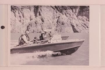 "RATTLESNAKE" and "CACTUS" cruising on Lake Mead. Lois Sanderson is hidden by Joe Desloge, Hugh Cutler sits amidships and Rod Sanderson is at the wheel. Ballard Atherton sits aft on the "CACTUS" while Bill Beer is at the wheel