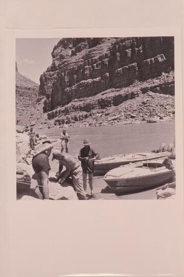 Replacing shields which were torn off the "BOOTOO" and the "CACTUS" in North Canyon Rapid. Left to right in foreground: Belknap, Sanderson, Taylor and Cutler. In background: Eisaman and Masland