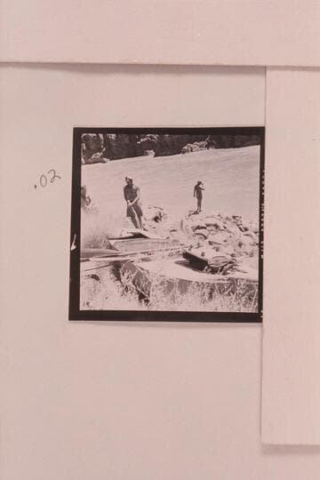 The Russell-Tadje boat "Ross Wheeler" on left bank above Bass Cable, Grand Canyon. Mile 108. Rod Sanderson and Claude Nichols examine the "Ross Wheeler" at Mile 108. Belknap at the River