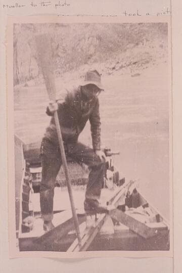 Ray Tankersley standing in the sweep-scow used by the Hyde couple in their effort to traverse the Grand Canyon in 1928.  The photograph is at Bright Angel Creek where Tankersley packed supplies for the lower end of the journey