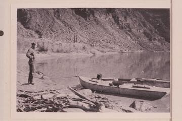 Jerry Johnson looking at the two Russell-Tadje boats at Lees Ferry