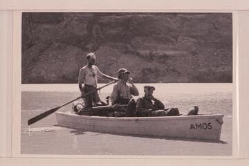 Frank Swain, Bill Chryst, Julius F. Stone in the "Amos" during traverse of Glen Canyon. Boat named for Amos Burg