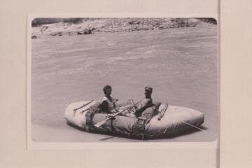 Fern and Bill Davis in their canvas-covered neoprene boat.  The inflated craft is 11 1/2 ft. long.  Cataract Canyon during run from Flaming Gorge to Bright Angel Creek
