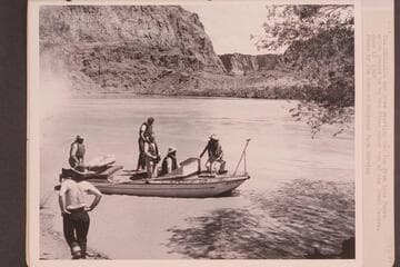 The "Esmeralda" [II] and crew starting the run from Lees Ferry which proved to be the first motor run of the Grand Canyon.  Owen Clark at left with back to camera.  Bestor Robinson; Edward Hudson; Willie Taylor; Ed Hudson; Dock Marston