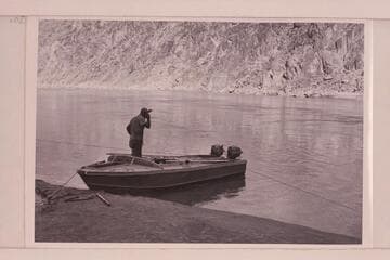 Rod Sanderson in the "Rattlesnake" used in the 1954, June Grand Canyon traverse. The boats were of aluminum and 18 feet long with 6 feet of beam. Power was from two 15HP Evinrude motors