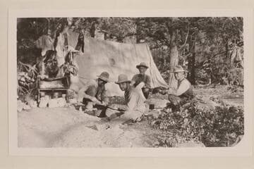 Camp of Uncle Jim Owen.  Uncle Jim has his back to the tent and faces the camera.  At right is John H. Davis, sheep man of Cannonville, Utah.  [And at left?] Two easterners who had come to Buckskin Mountain for a cougar hunt