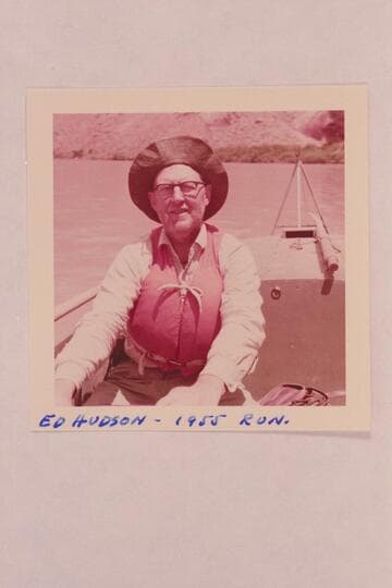 Ed Hudson, posed at wheel of "Finally" used in run from Fruita to Lees Ferry