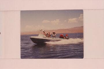 Buzz Belknap piloting the "Cactus" on Lake Mead. Buzz Belknap at the wheel, Jeff Marston, Jim Jordan, Elsie I'Anson and Ed I'Anson