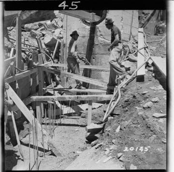 View of excavation for 42" sluice pipe upper end after concrete foundation was poured up to base of 12" bearing wall