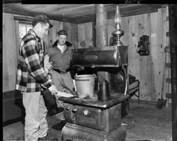 Two men in Kaiser Meadow shelter cabin used during snow surveys