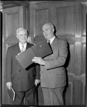 Two men looking at book