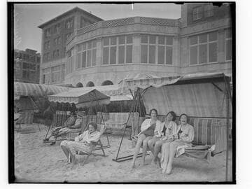 Swim team in beach chairs in front of the Club Casa del Mar, Santa Monica, California