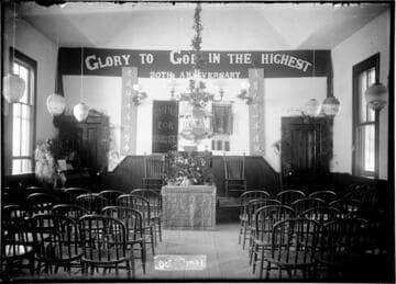 Interior of church with banners in English and Chinese